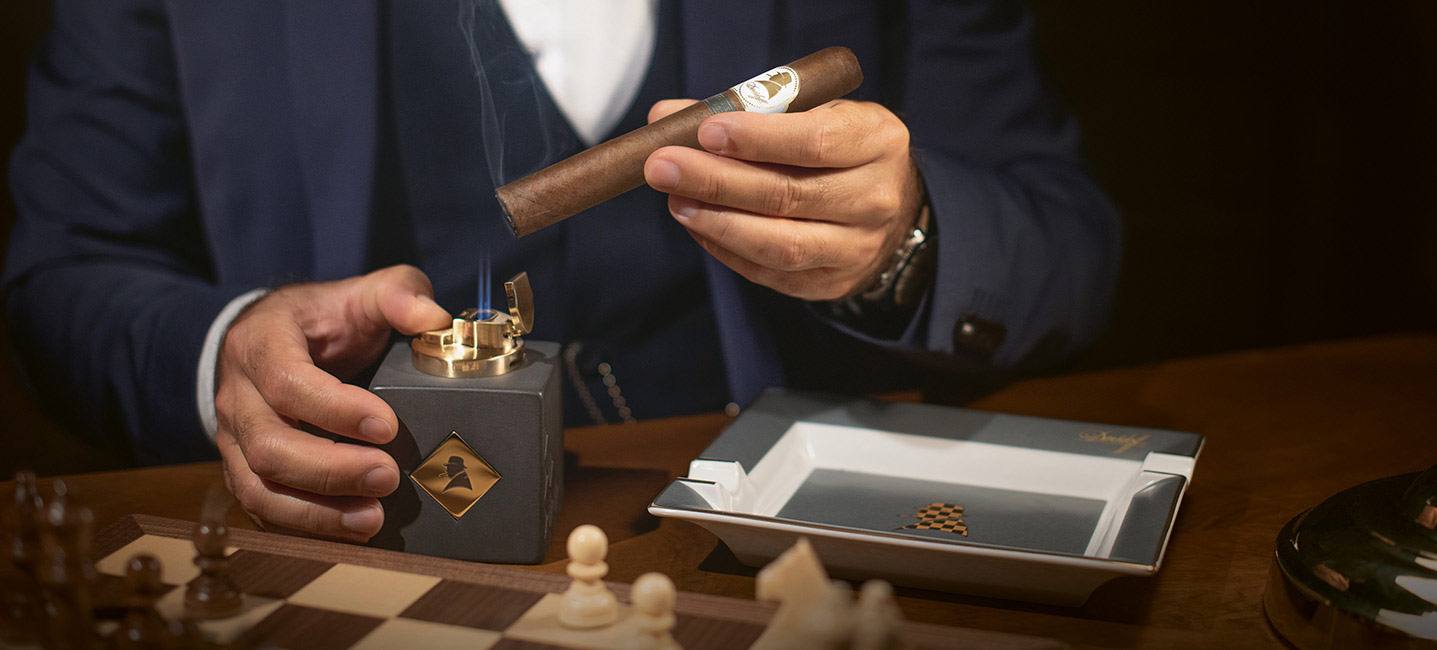 The Davidoff Winston Churchill Cigar 2021 being lit with the table lighter